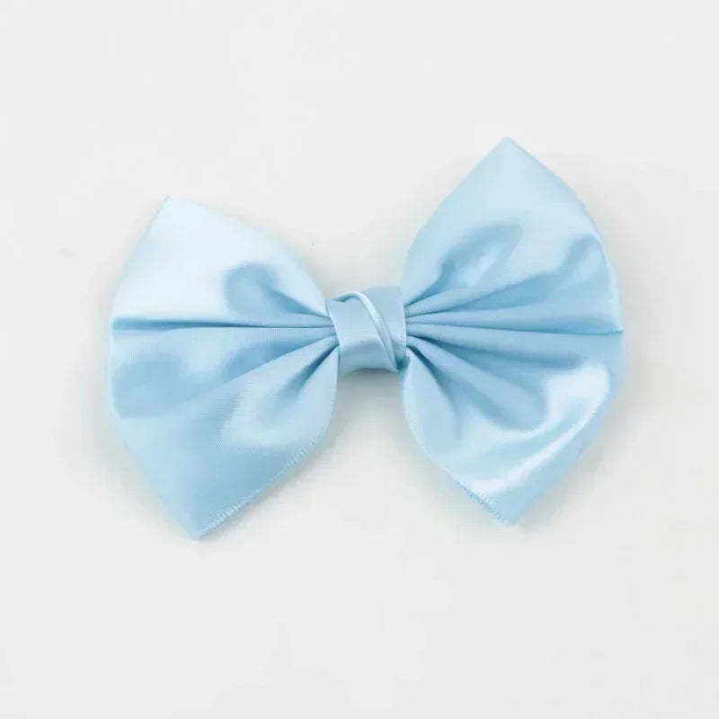 Light blue silk hair bow tied in a classic bow shape