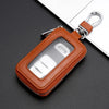 A brown leather pouch with a clear window and silver clasp, designed to protect a car key.