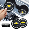 A set of black and yellow Chevrolet branded waterproof coasters shown in a car interior