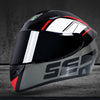 A black and silver full face motorcycle helmet with red accents shown against a dark background.