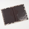 A dark brown leopard print passport holder with card slots shown open.
