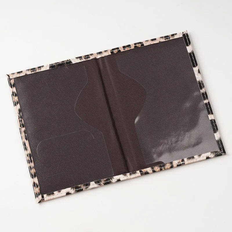 A dark brown leopard print passport holder with card slots shown open.