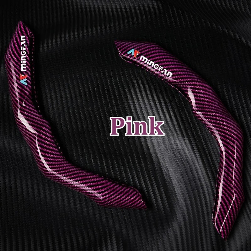 Pink carbon fiber steering wheel cover with Minican branding shown on a black background.
