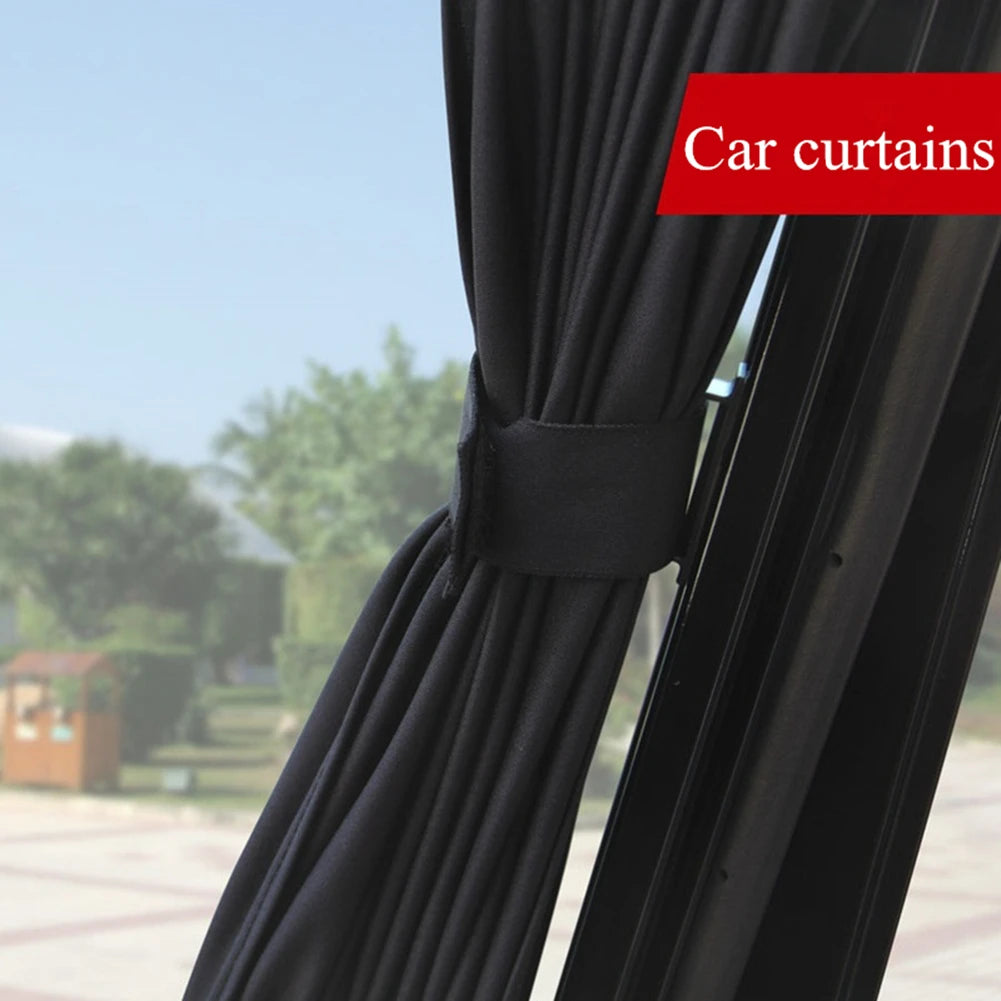 Black car curtains drawn on a side window, showing the fabric texture and mounting.