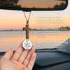 A handcrafted wooden cross pendant with a tag is shown hanging from a cord, ready to be used as a faith reminder.