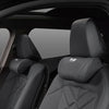 Close-up view of a black leather car seat with an S-Class leather soft headrest and neck pillow.