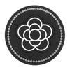 A black silicone car cup coasters set with a white floral design and clear crystal borders.