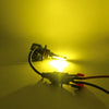 A bright yellow-green fog light bulb is illuminated against a dark background.