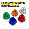 A collection of four colored LED marker lights, including green, orange, red, and blue, shown with water droplets.