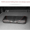 A black car seat protector cover is shown folded on a dark surface.