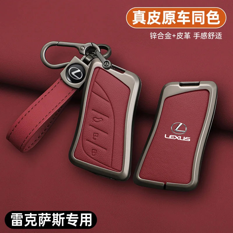 A leather car key cover shell in a maroon color with a metal clip and strap shown against a dark red background.