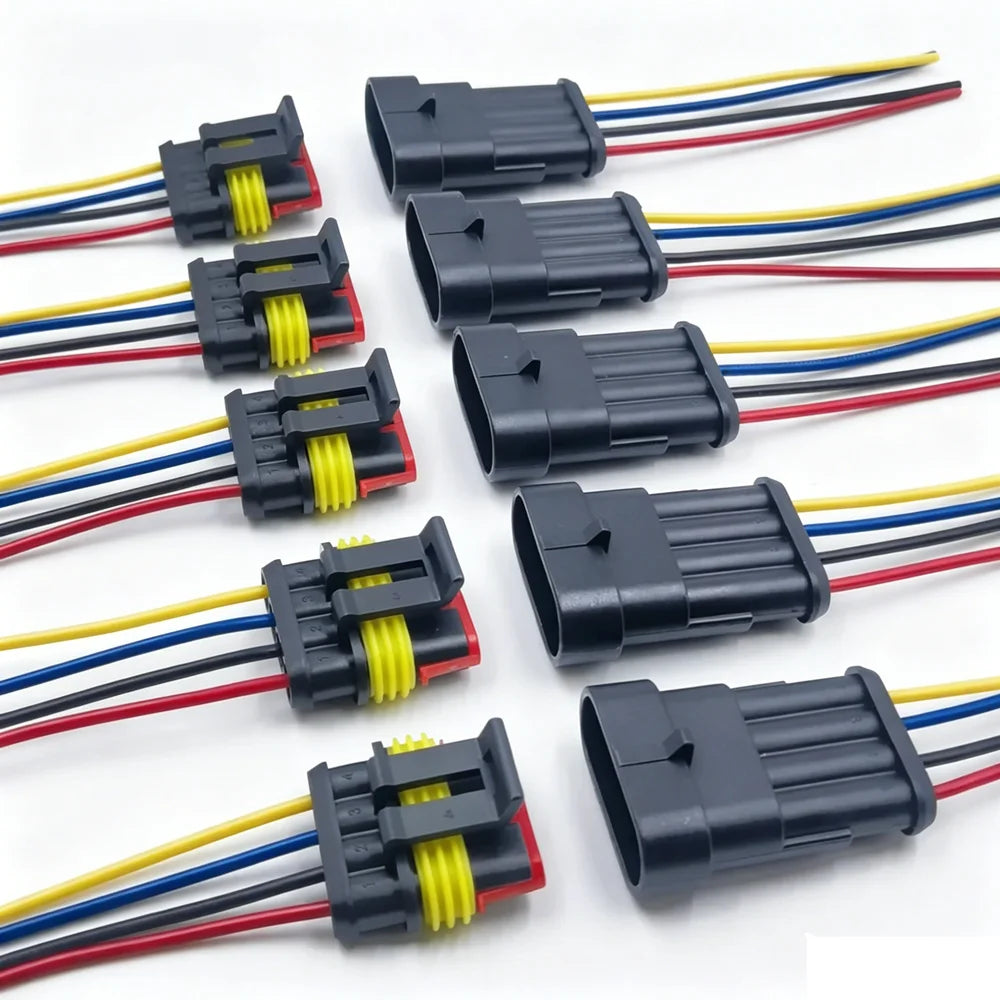 A collection of waterproof electrical connectors with pre-wired leads in black, yellow, and red colors.