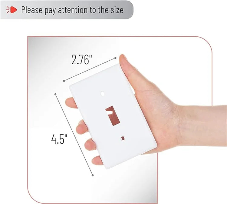A hand holds a white electrical light switch cover plate, showing its size dimensions.