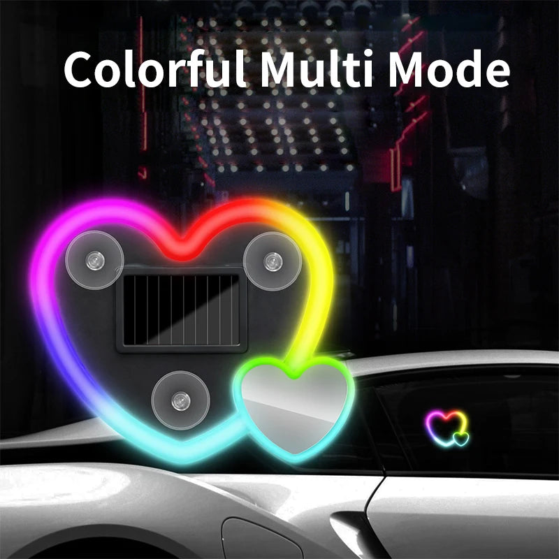 A decorative heart-shaped solar lamp with colorful multi-mode lighting illuminating a car interior.