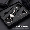A black box containing a carbon fiber leather car key chain with a zinc alloy keyring.