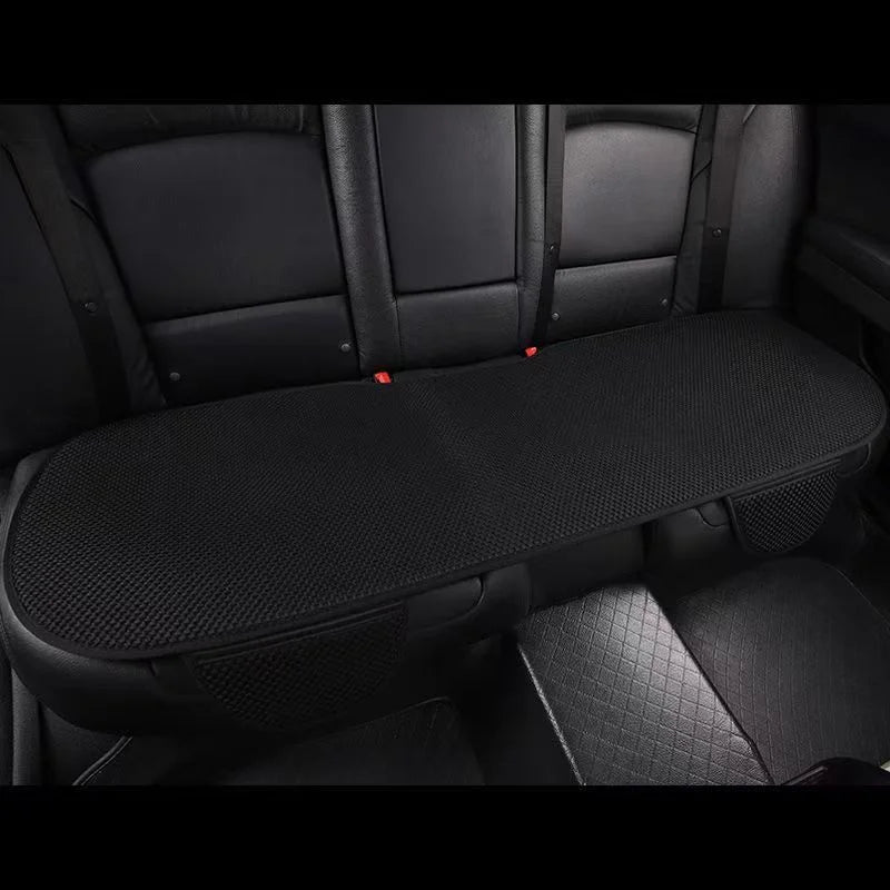A black breathable ice silk car seat cushion is shown inside a vehicle cabin.