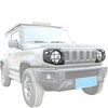 Un Suzuki Jimny blanc avec des phares et feux arrière modifiés.