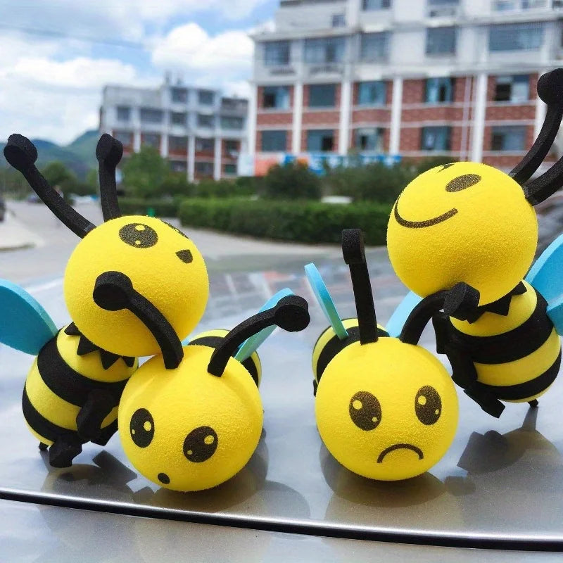 A set of yellow bee-shaped antenna decorations with black stripes and blue wings.