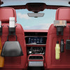 Interior view of a red car seat showing various cup holder hooks and storage accessories.