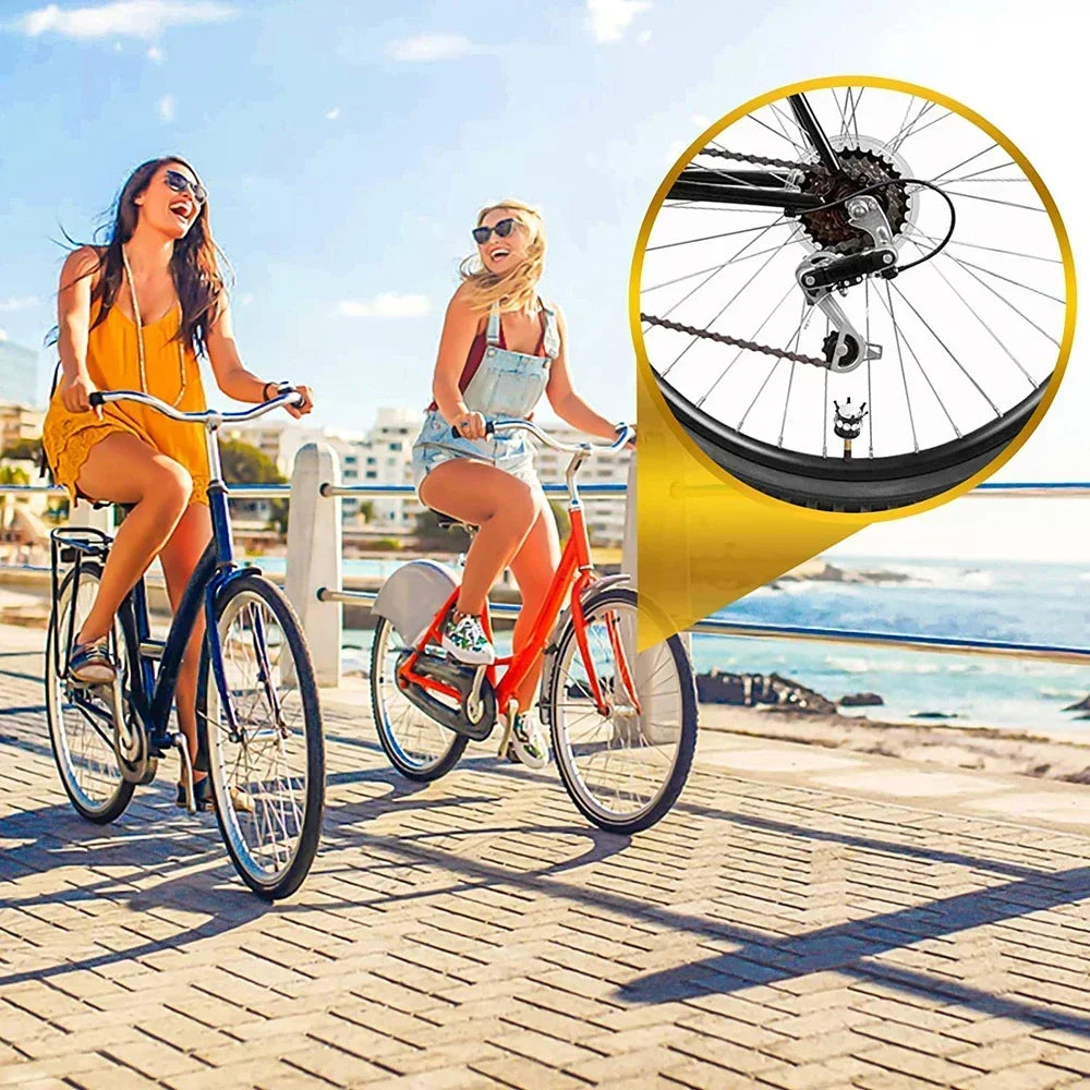 Two women riding bicycles on a boardwalk with a close-up of a bicycle tire valve cap set.
