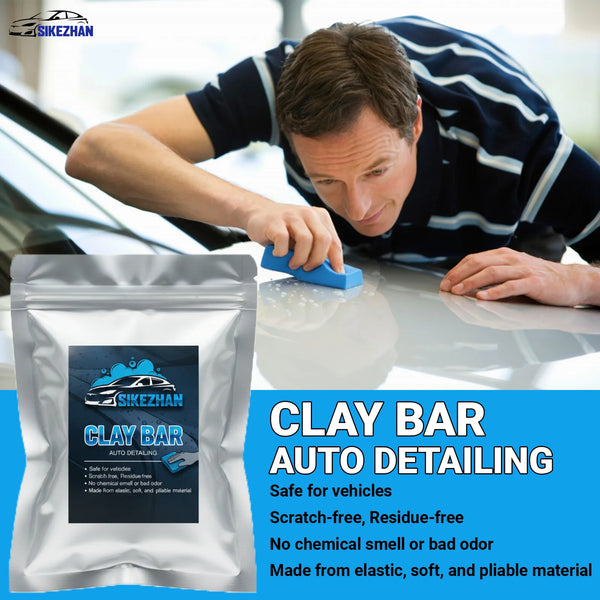 A man is using a blue clay bar on a car surface for auto detailing.