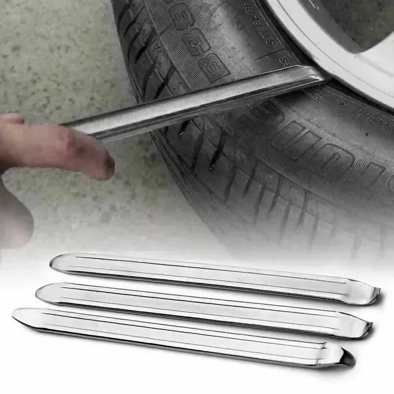 A set of metal tire wrenches and rim openers shown next to a tire.