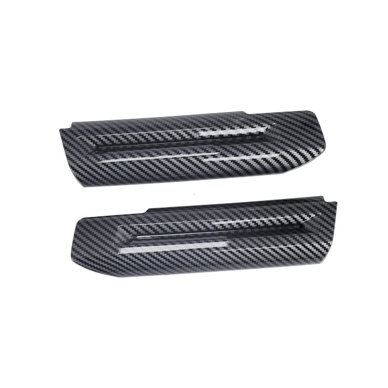 Black carbon fiber trim for a car interior door handle.