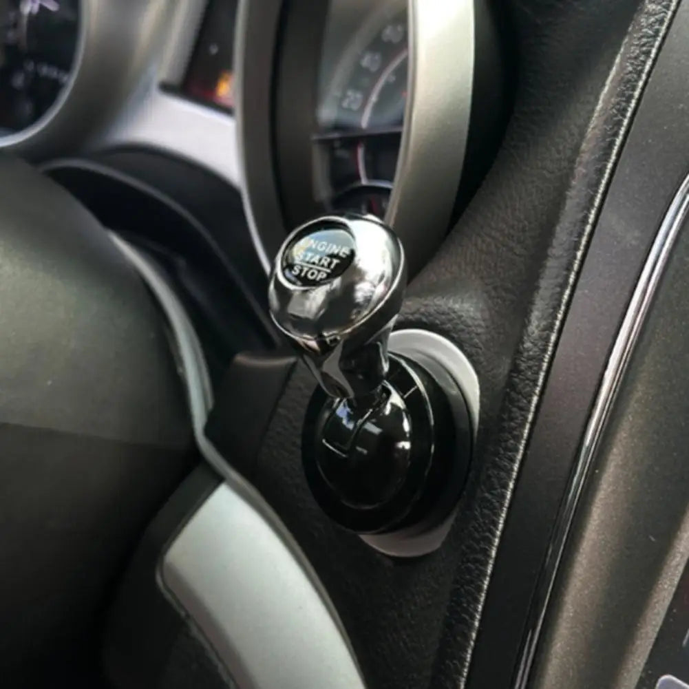 Close-up of a shiny metal engine start stop lever mounted on a car dashboard.