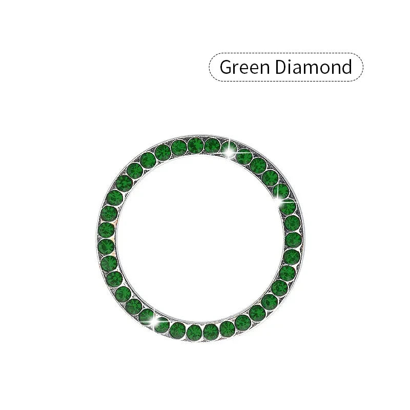 A circular decorative ignition push button cover made of green diamond stones.