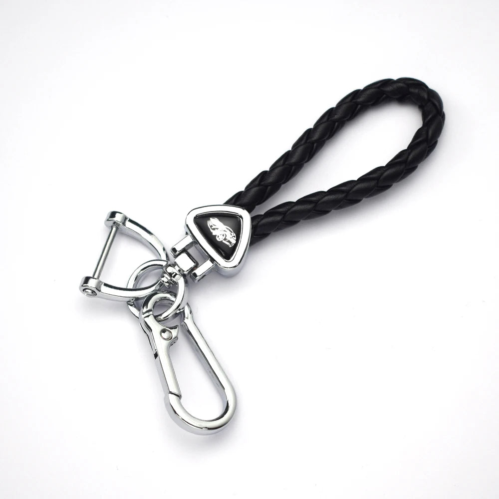 A black braided leather key cover with a silver clasp and tag.
