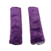 A pair of purple luxury car seatbelt shoulder pads.