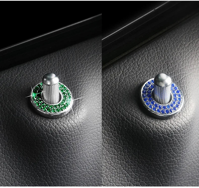 A close-up of an elegant car door lock pin trim set showing two versions: one with green stones and one with blue stones.