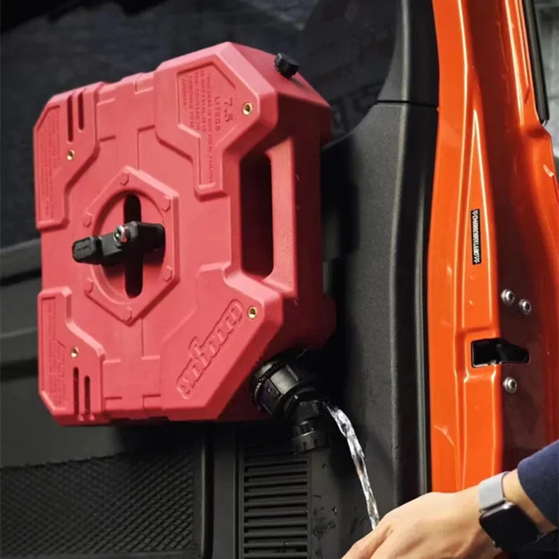 A red universal fuel can to water tap adapter is shown mounted on a black surface.
