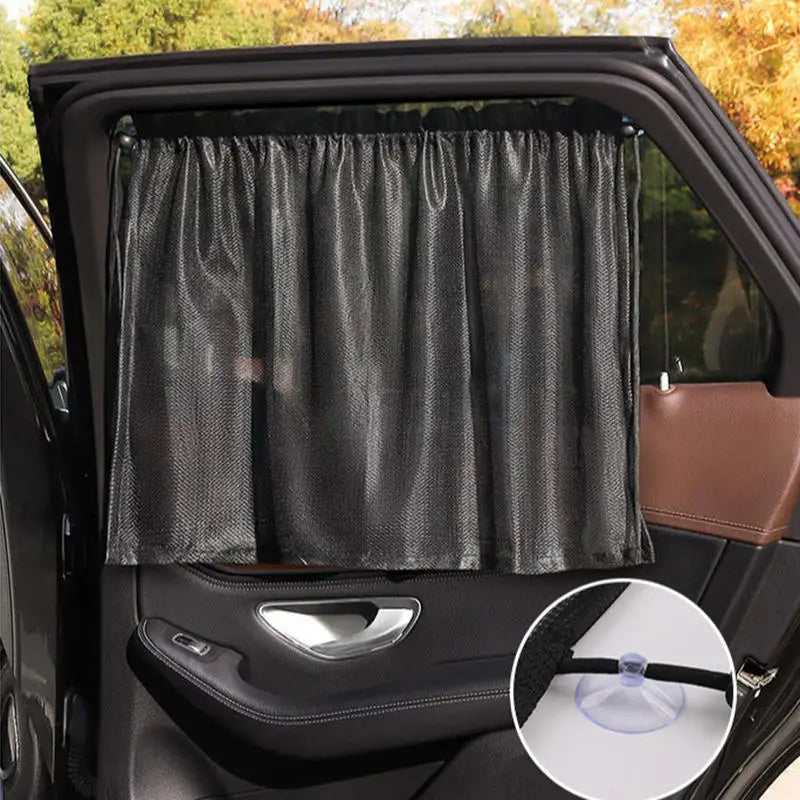 Black suction cup window sunshade installed in a car window.