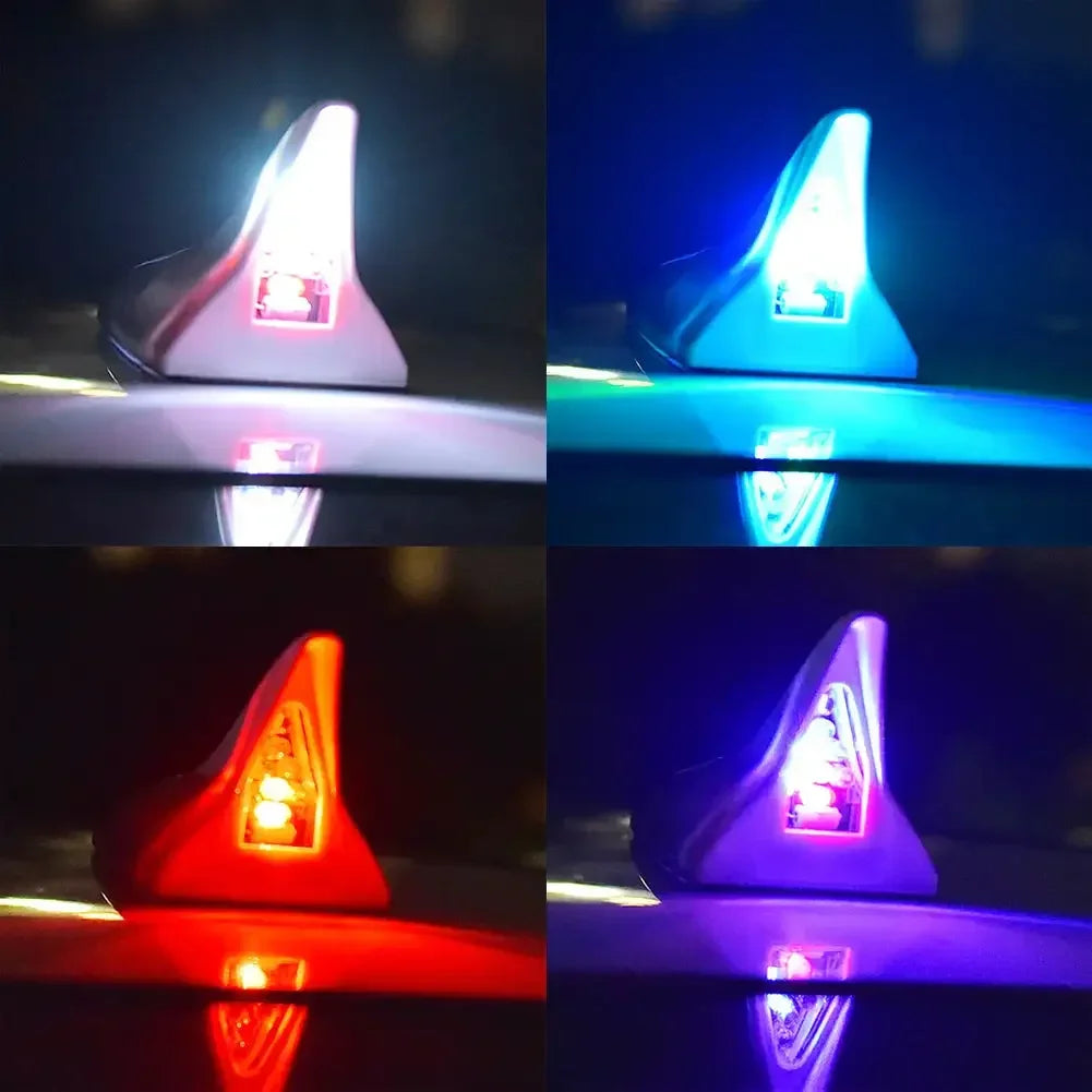 Four views of a solar car antenna shark fin roof light illuminating different colors.