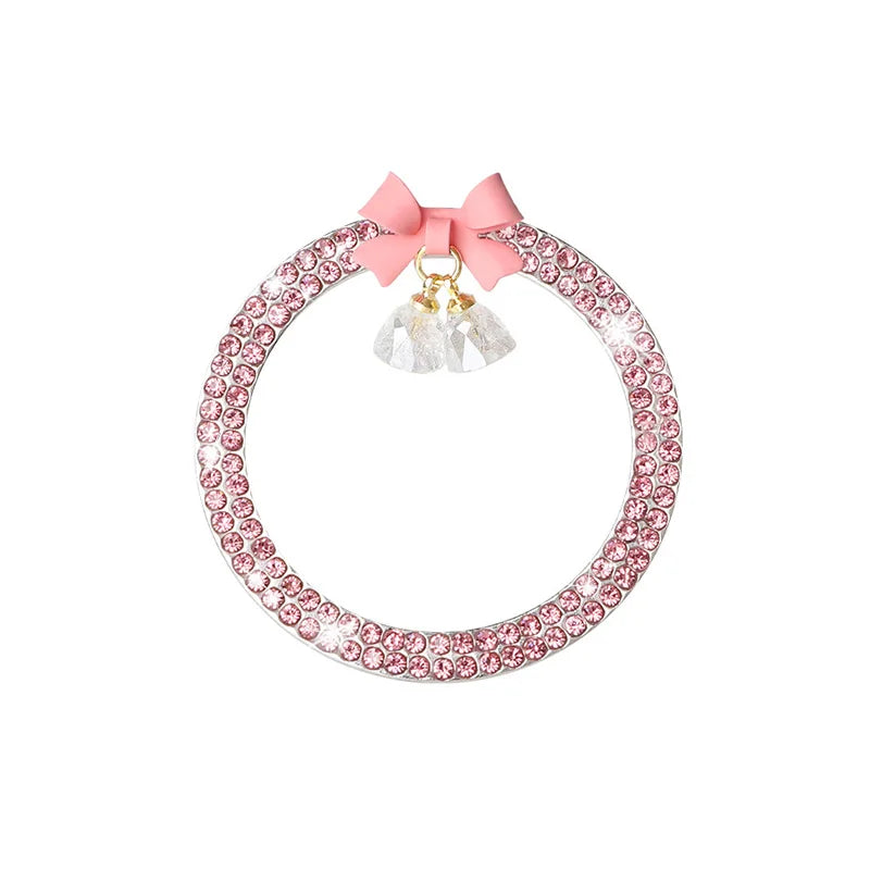 A pink rhinestone bow bell trim featuring clear crystal accents.