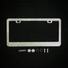 A rectangular license plate frame decorated with sparkling crystal rhinestones and mounting tabs.