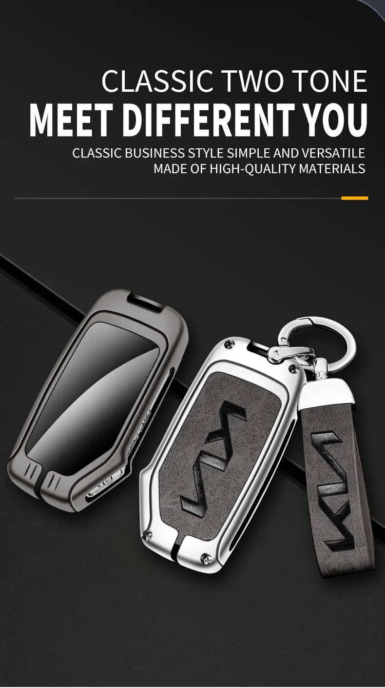 A black leather alloy car key case and a matching key fob are shown on a dark background.