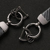 Silver luxury carbon fiber style keychains with metal split rings displayed on a black background