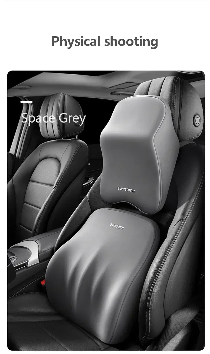 A close-up view of a grey ergonomic car headrest cushion installed in a vehicle seat.