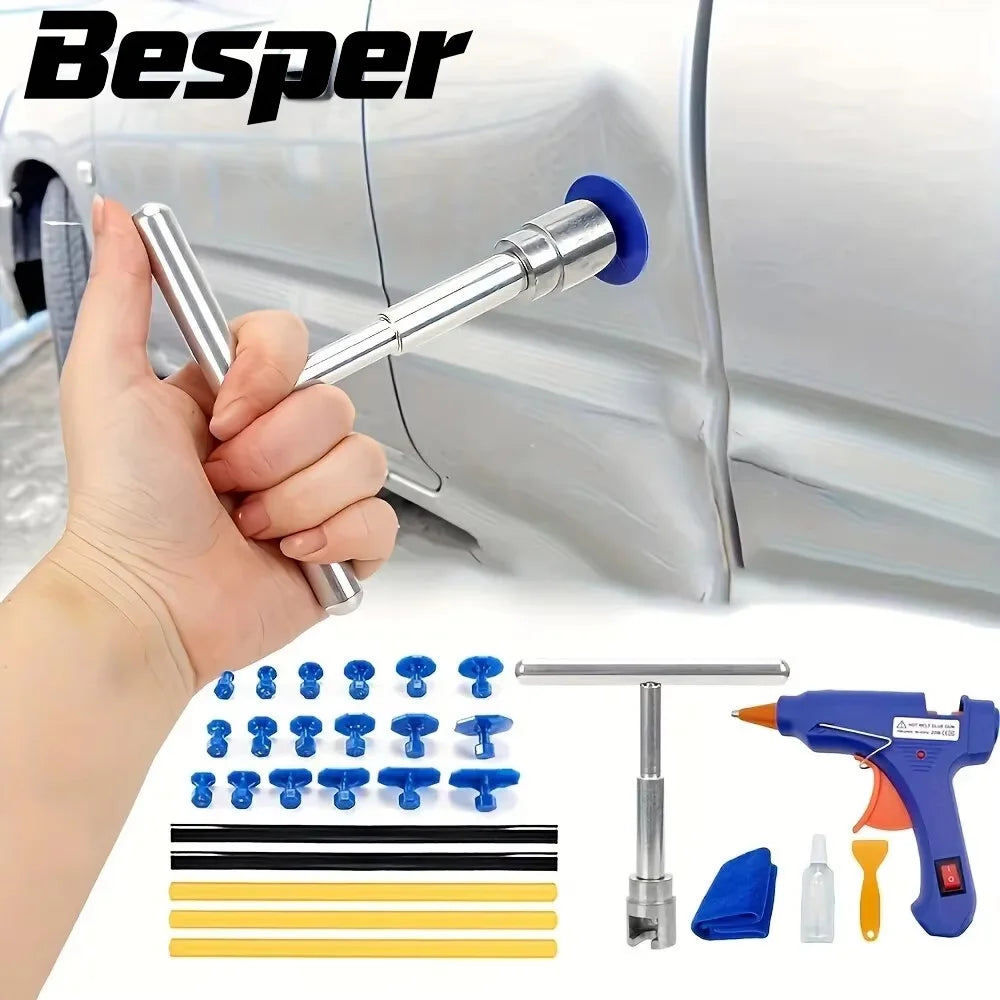 A hand is using a professional auto dent repair kit tool on a silver car panel.