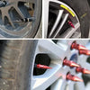 Close-up view of aluminum tire valve stem caps being installed into a wheel rim.