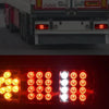 Close-up view of dual high-brightness red tail lights on a commercial truck.