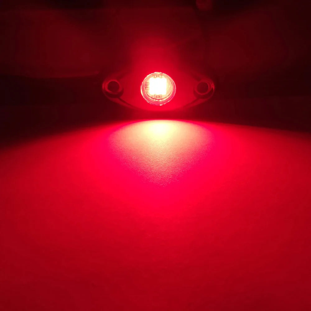 A close-up of a red LED light shining brightly onto a surface.