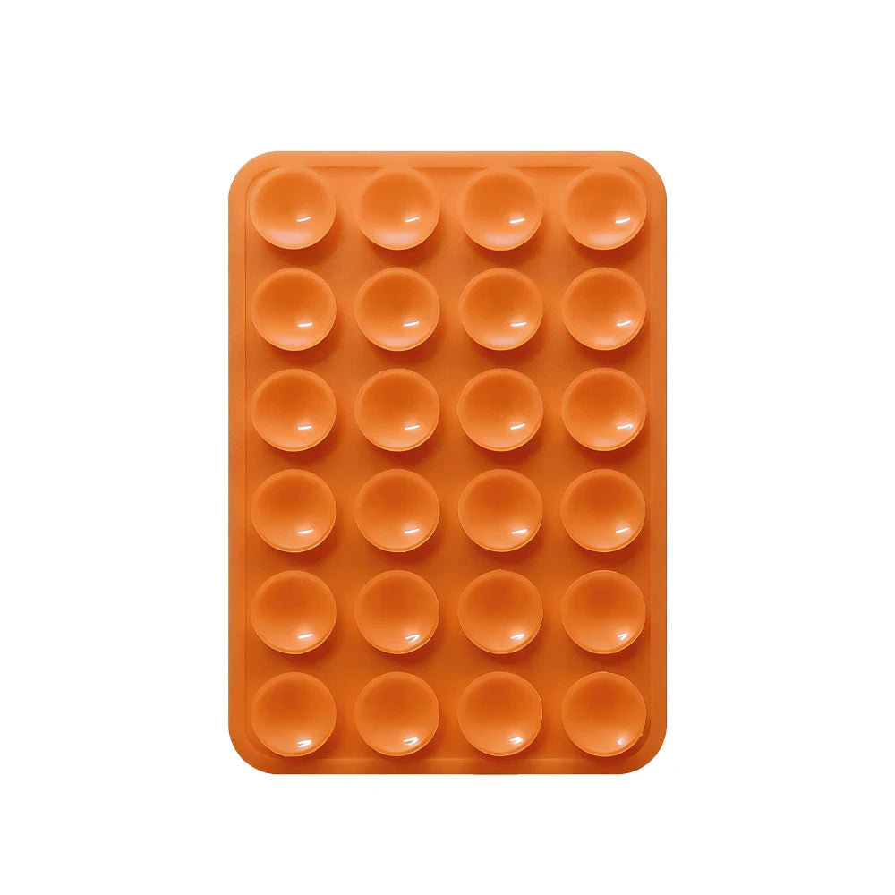 Orangefarbige Silikon-Saugnapf-Handyhalterung mit mehreren runden Pads zum Befestigen von Geräten.