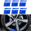 A close-up view of a black alloy wheel with a silver center cap and blue accents.