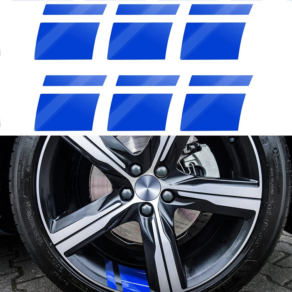 A close-up view of a black alloy wheel with a silver center cap and blue accents.