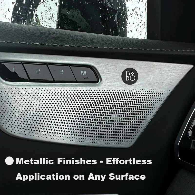 Close-up of a car interior panel showing controls and a metallic finish texture.