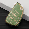 A light green multi-function car key cover with gold trim resting on a dark surface.