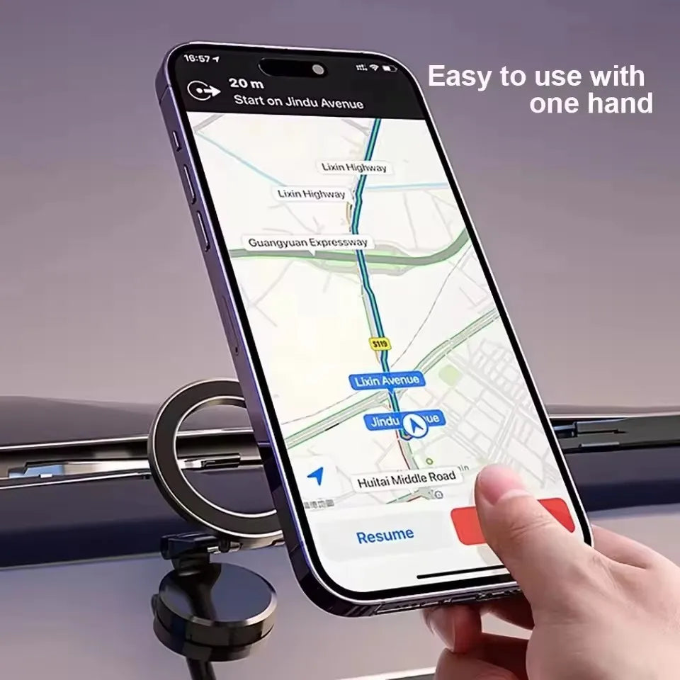 A hand holds a smartphone displaying a map with navigation instructions, mounted on a car accessory.